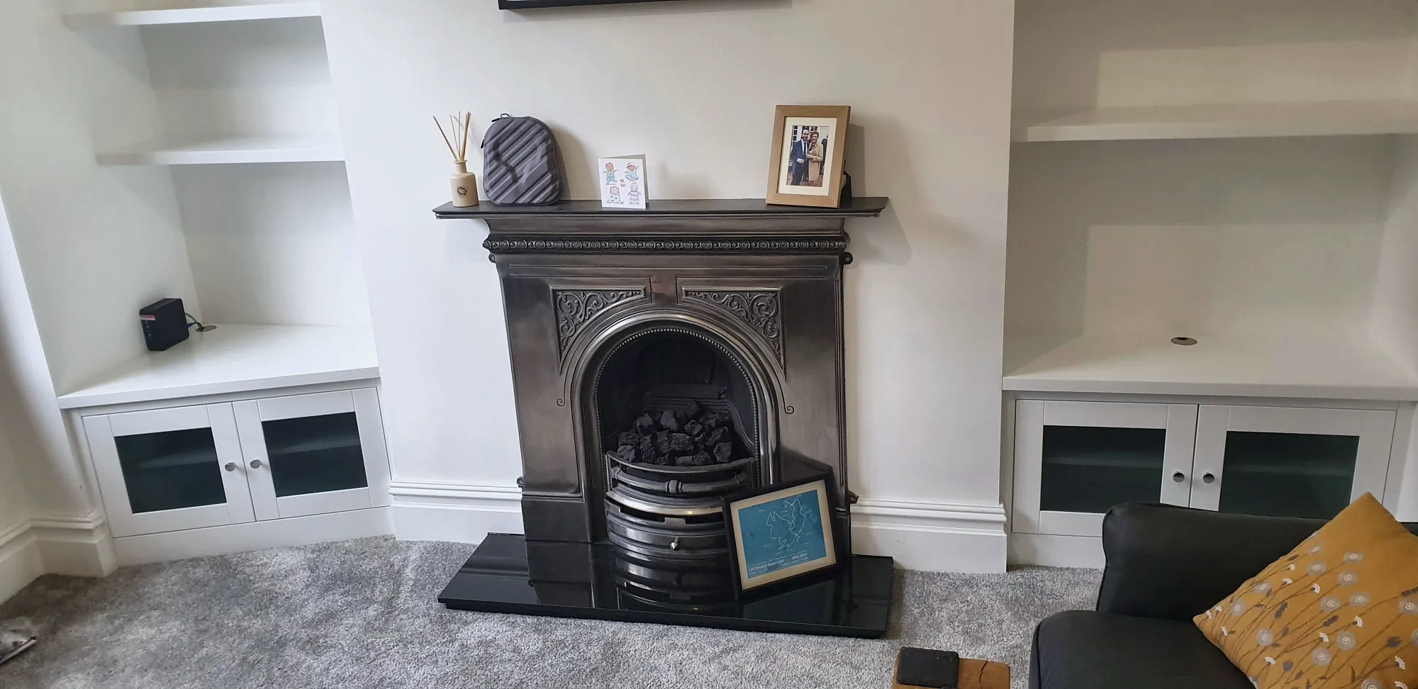 Painted alcove units either side of a cast-iron fireplace