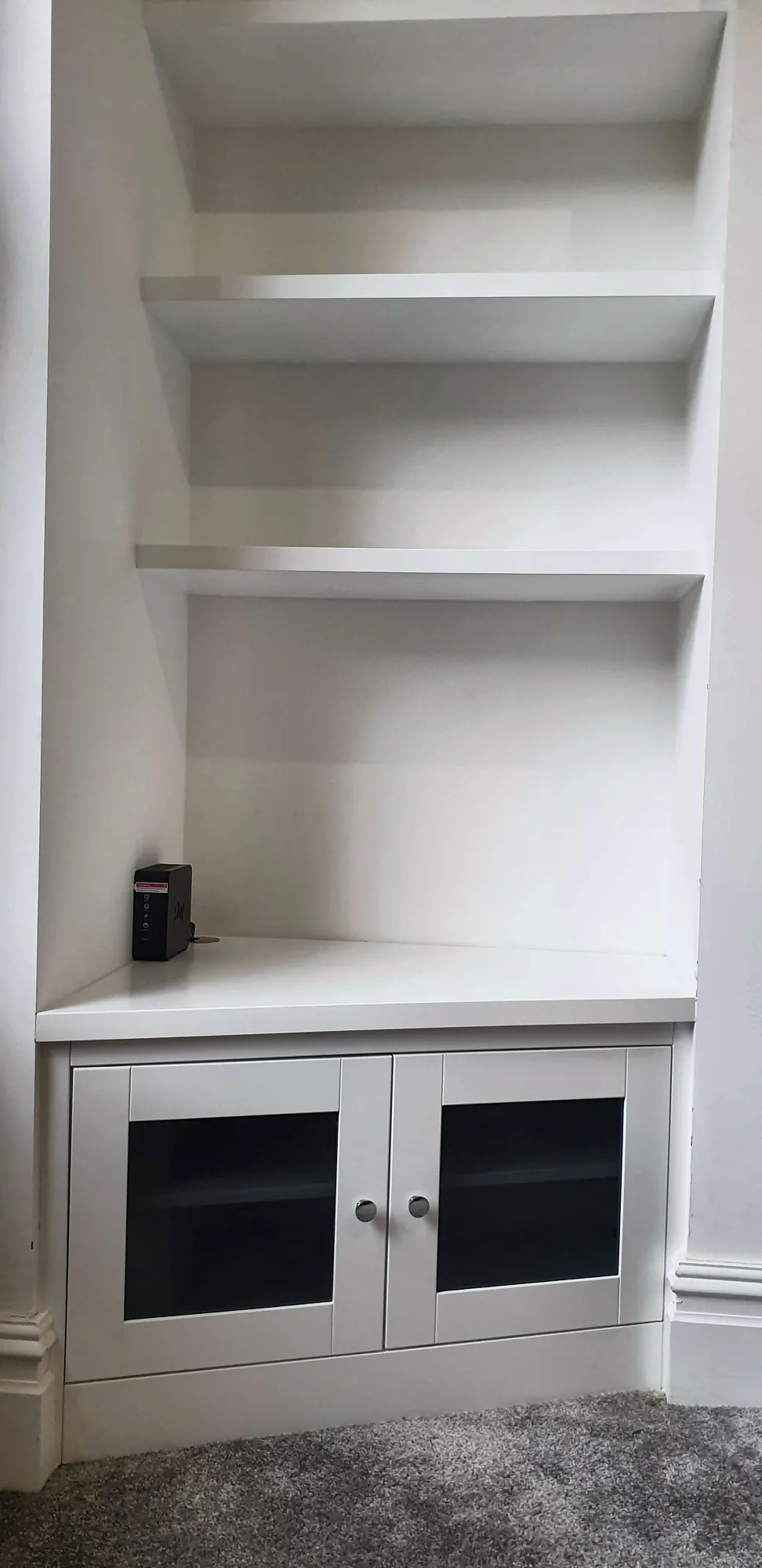 Floating shelves above a glazed cabinet
