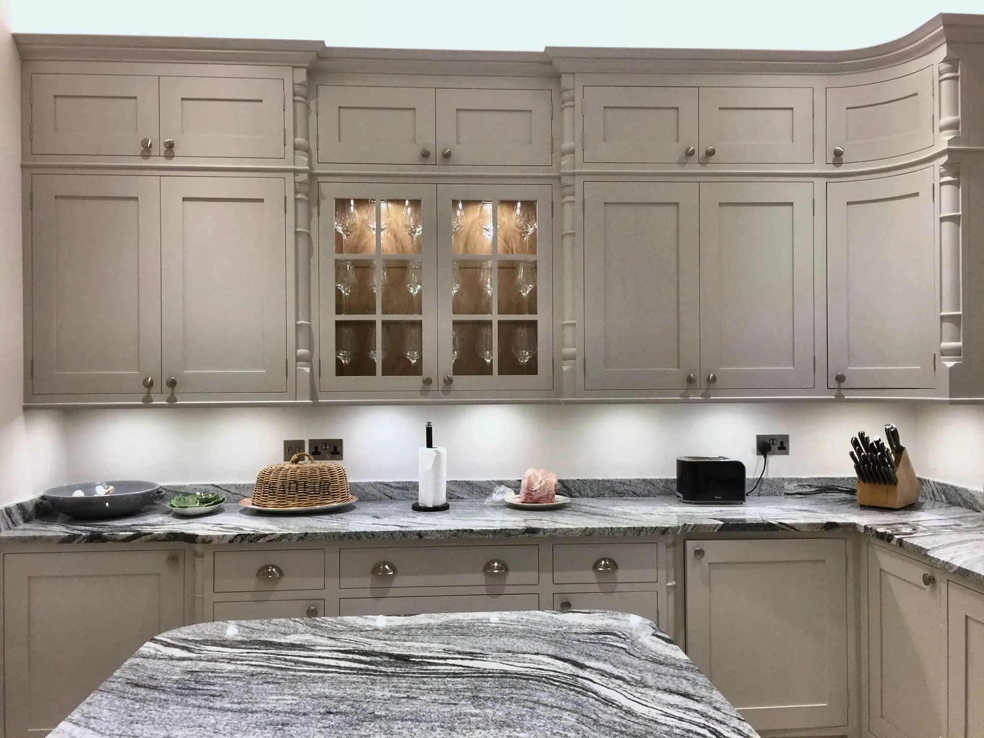 Painted kitchen with glazed, lit display cabinets