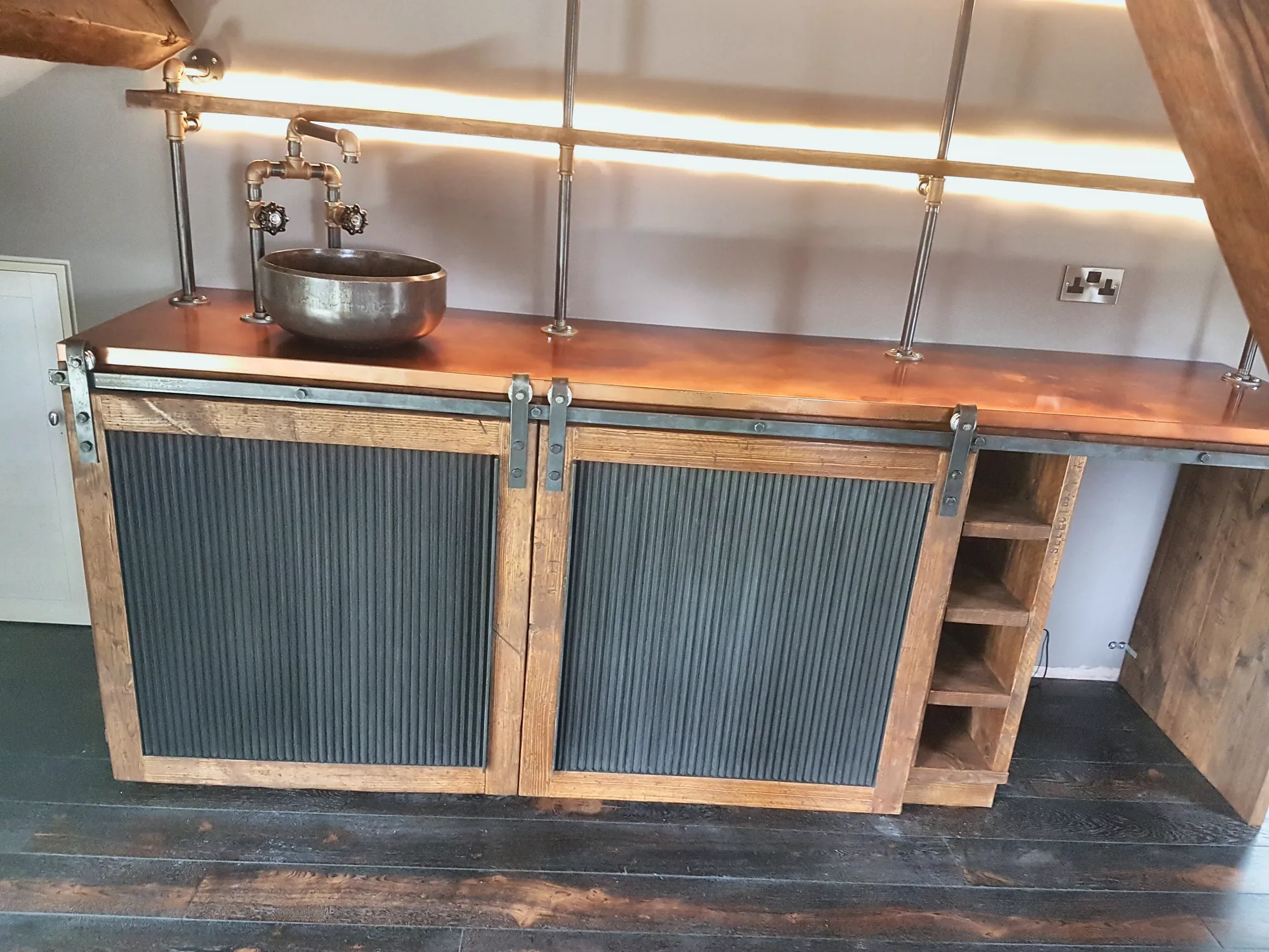 Industrial vanity with a copper top and sliding doors