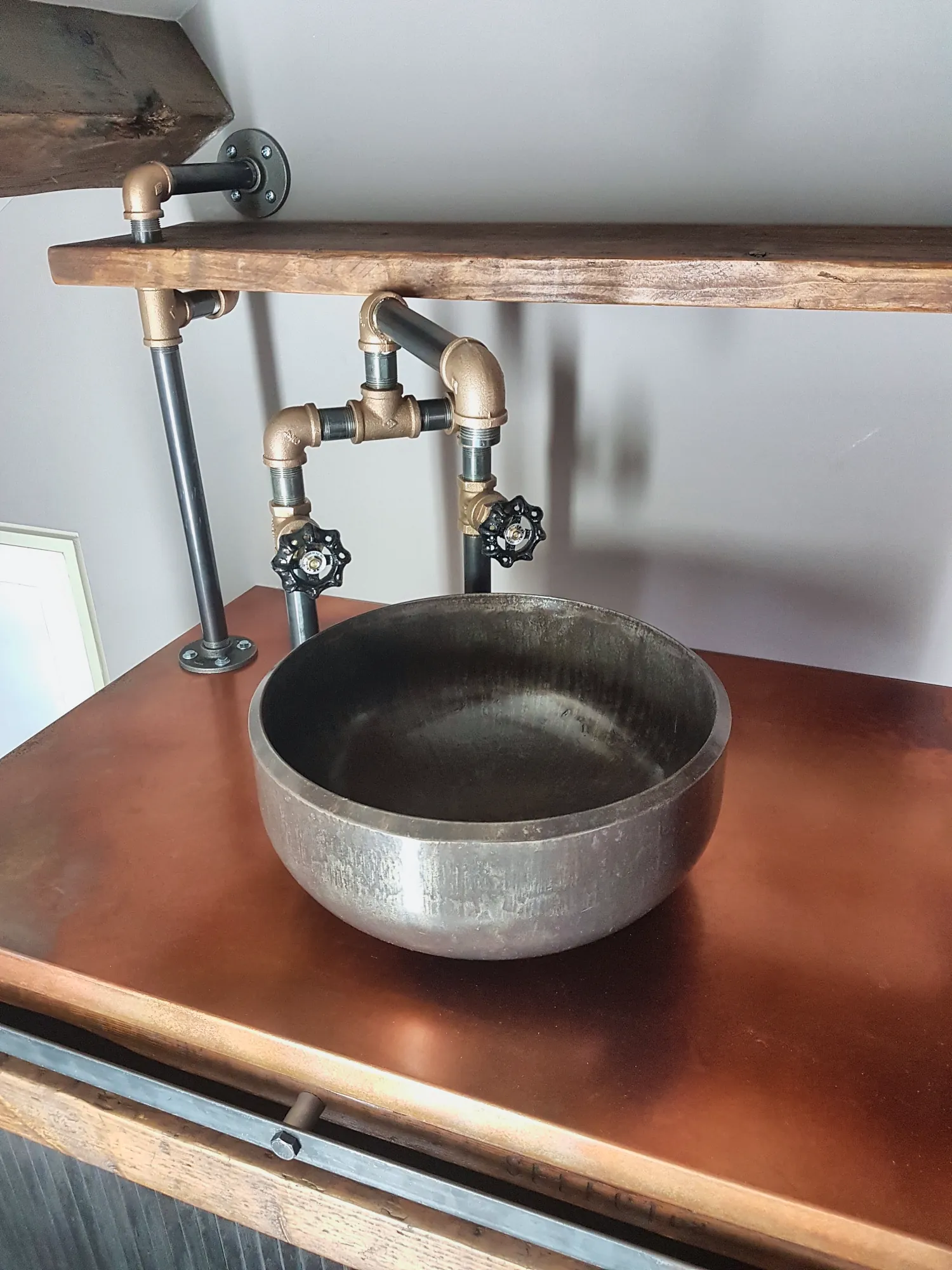 Hammered basin and pipe-work tap on the copper top