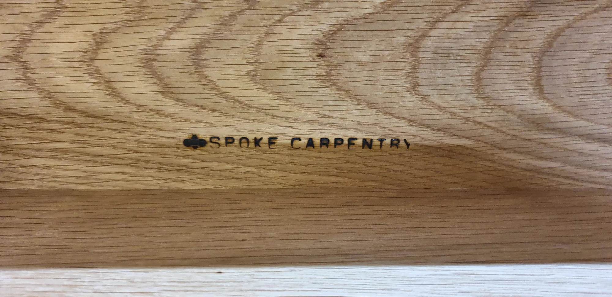 The Beespoke mark engraved into oak