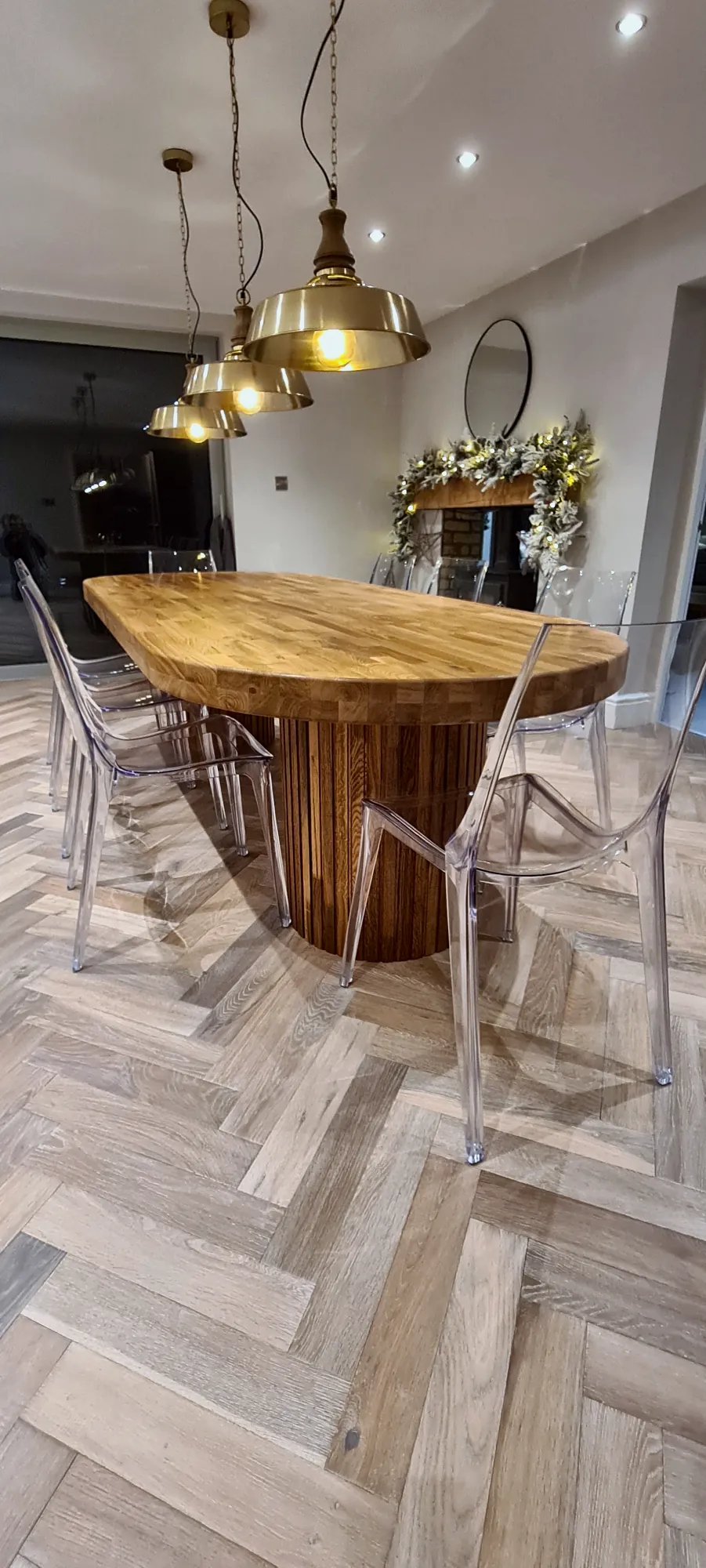 Oval hardwood dining table on a slatted pedestal