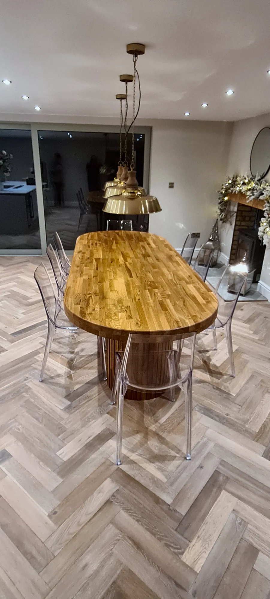 The dining table beneath brass pendant lights