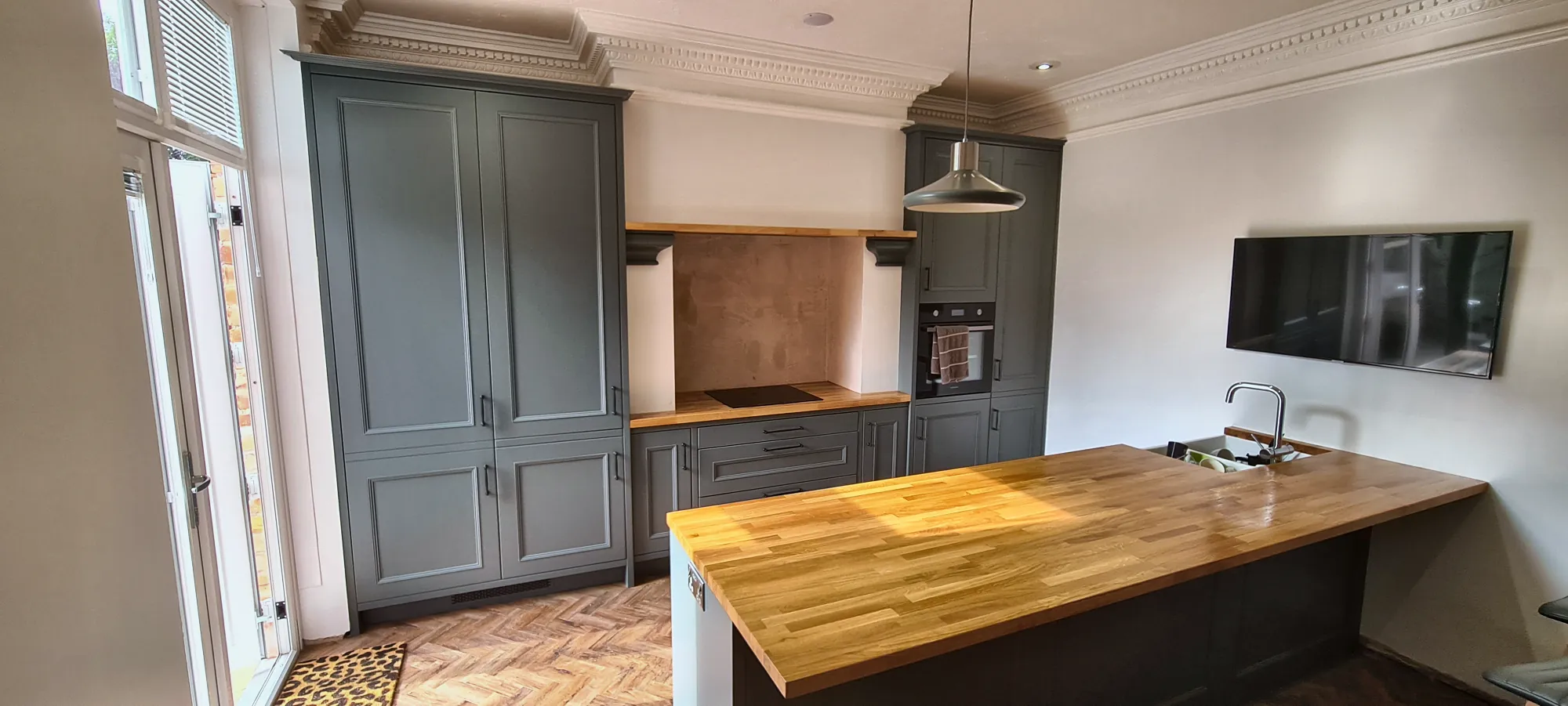 Island and tall units on herringbone flooring