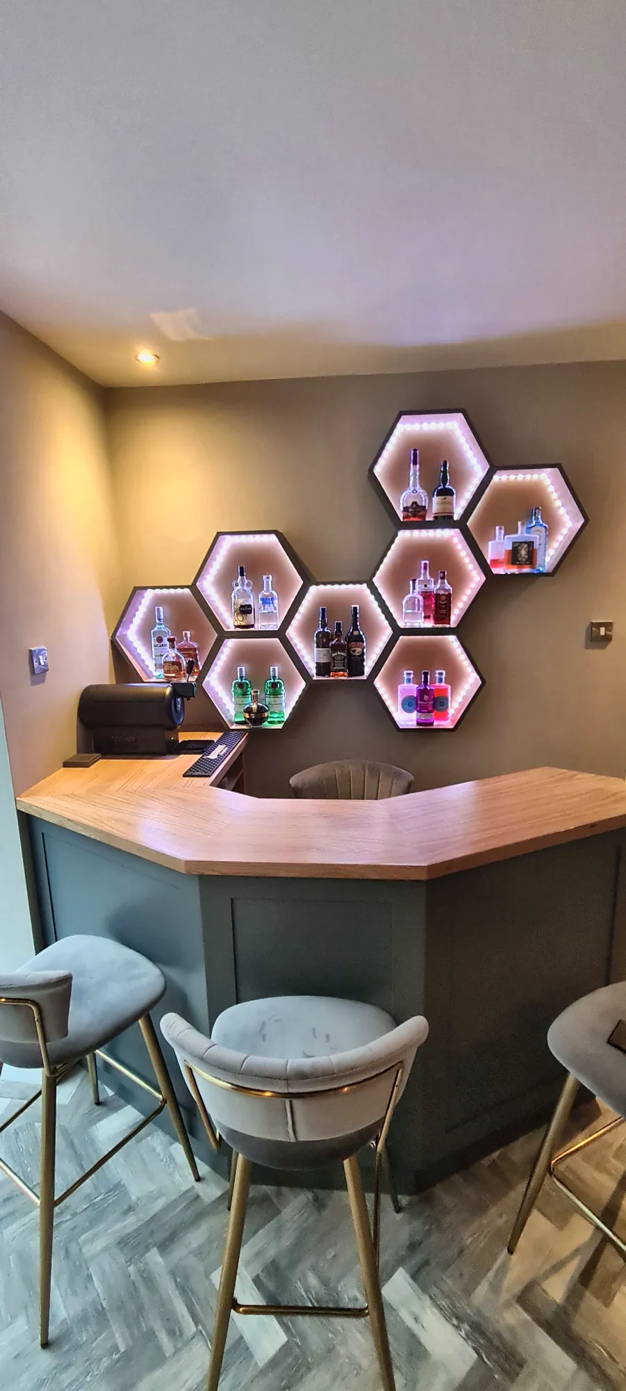 The bar finished with stools and lit display hexagons