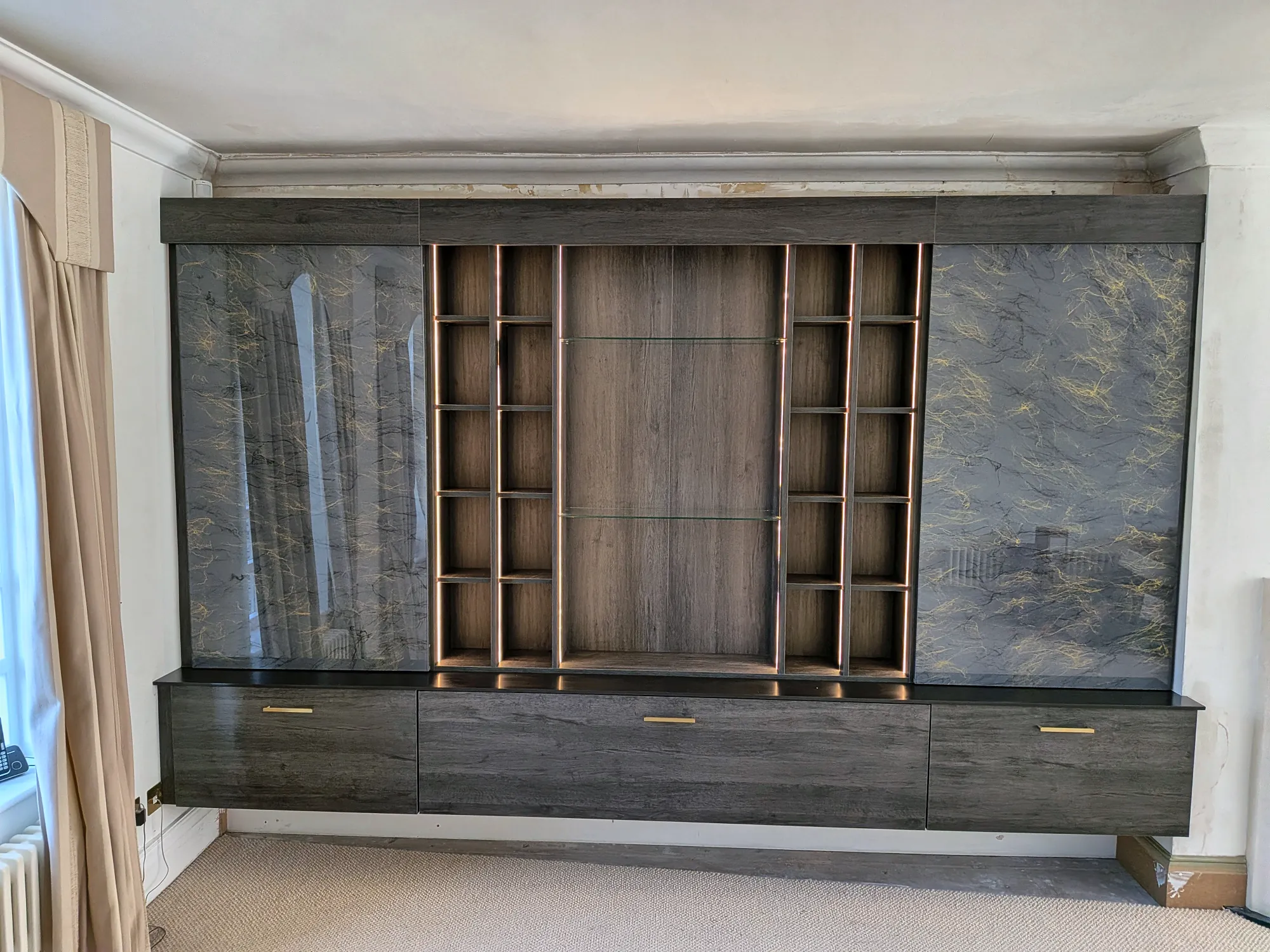 The finished media wall across the full width of the living room