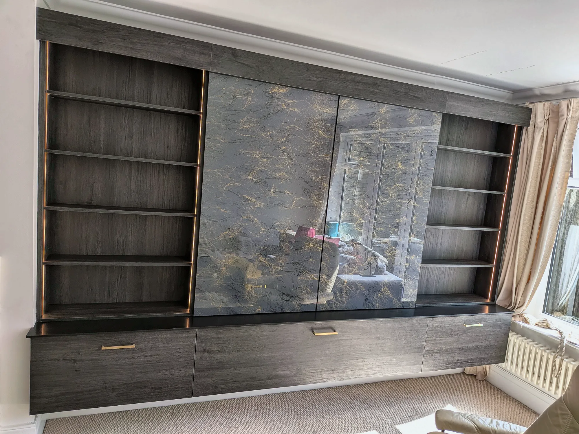 A sliding panel drawn across to reveal the shelving