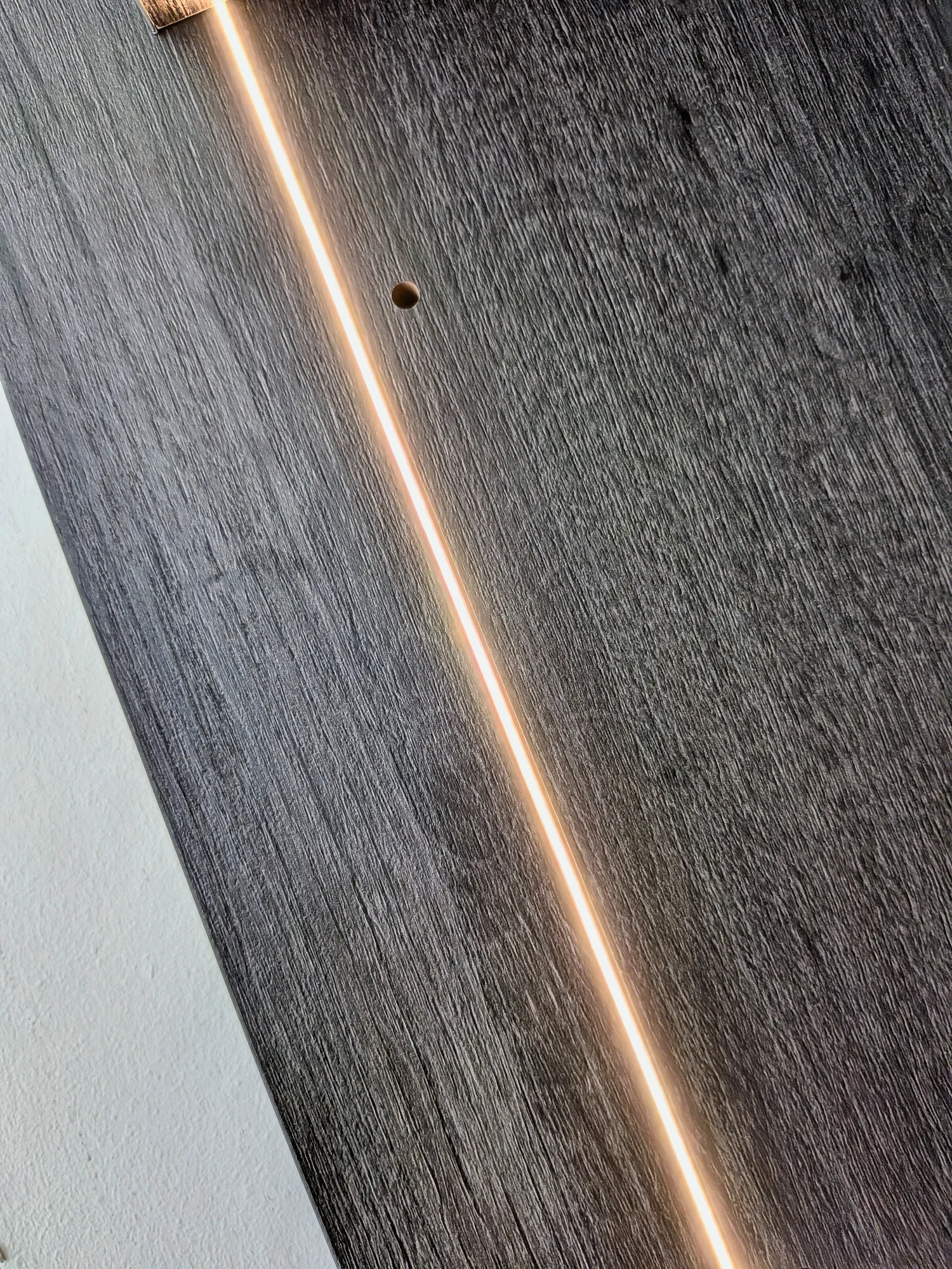 Recessed LED strip running along the oak