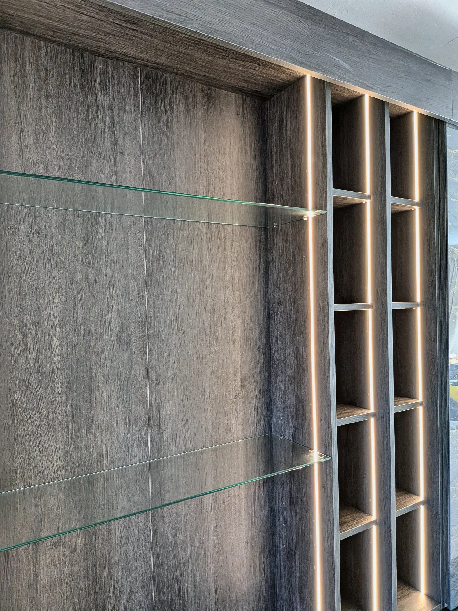 Glass shelves and warm lighting inside the cabinet