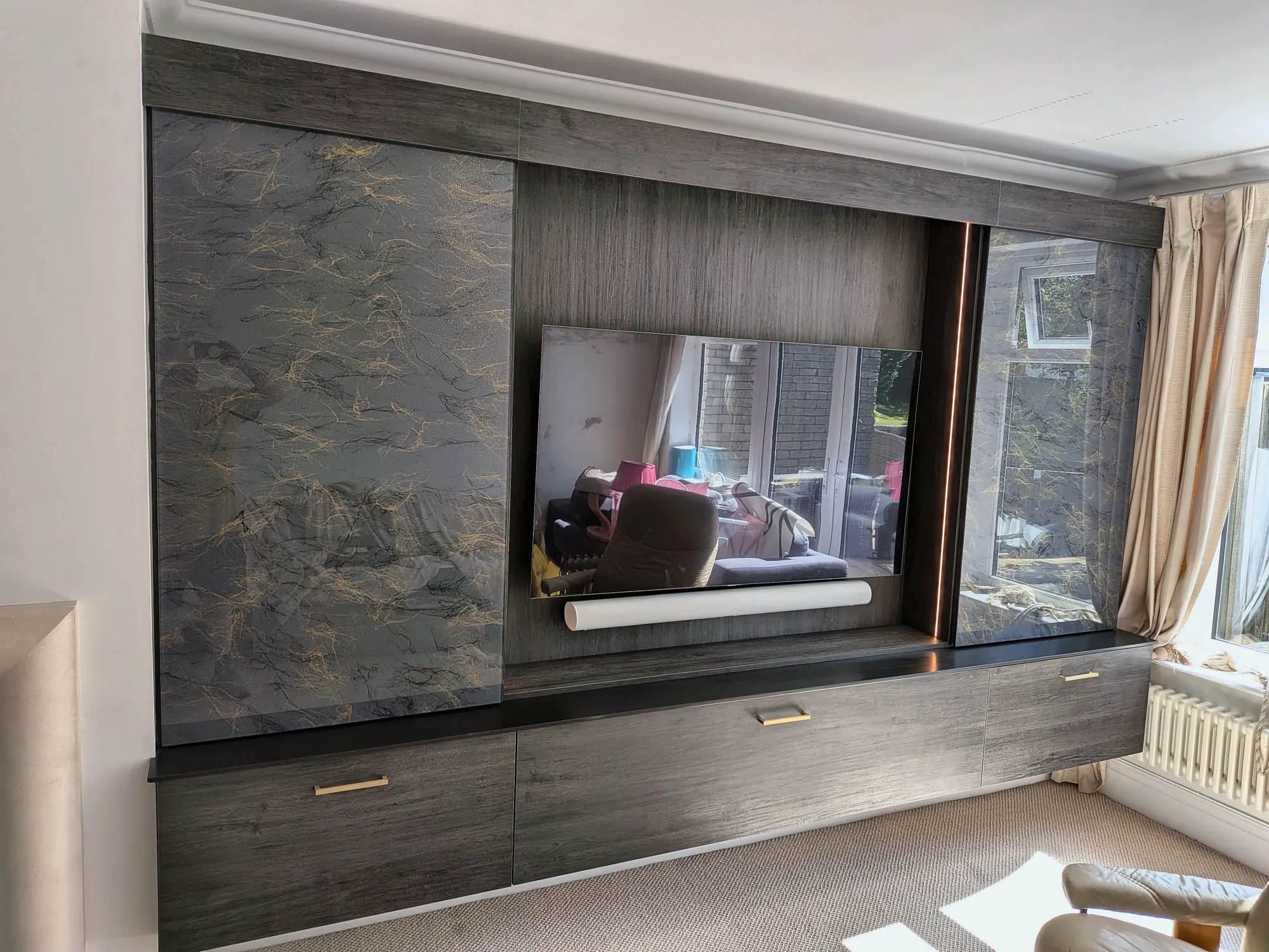 The television revealed behind the sliding panels