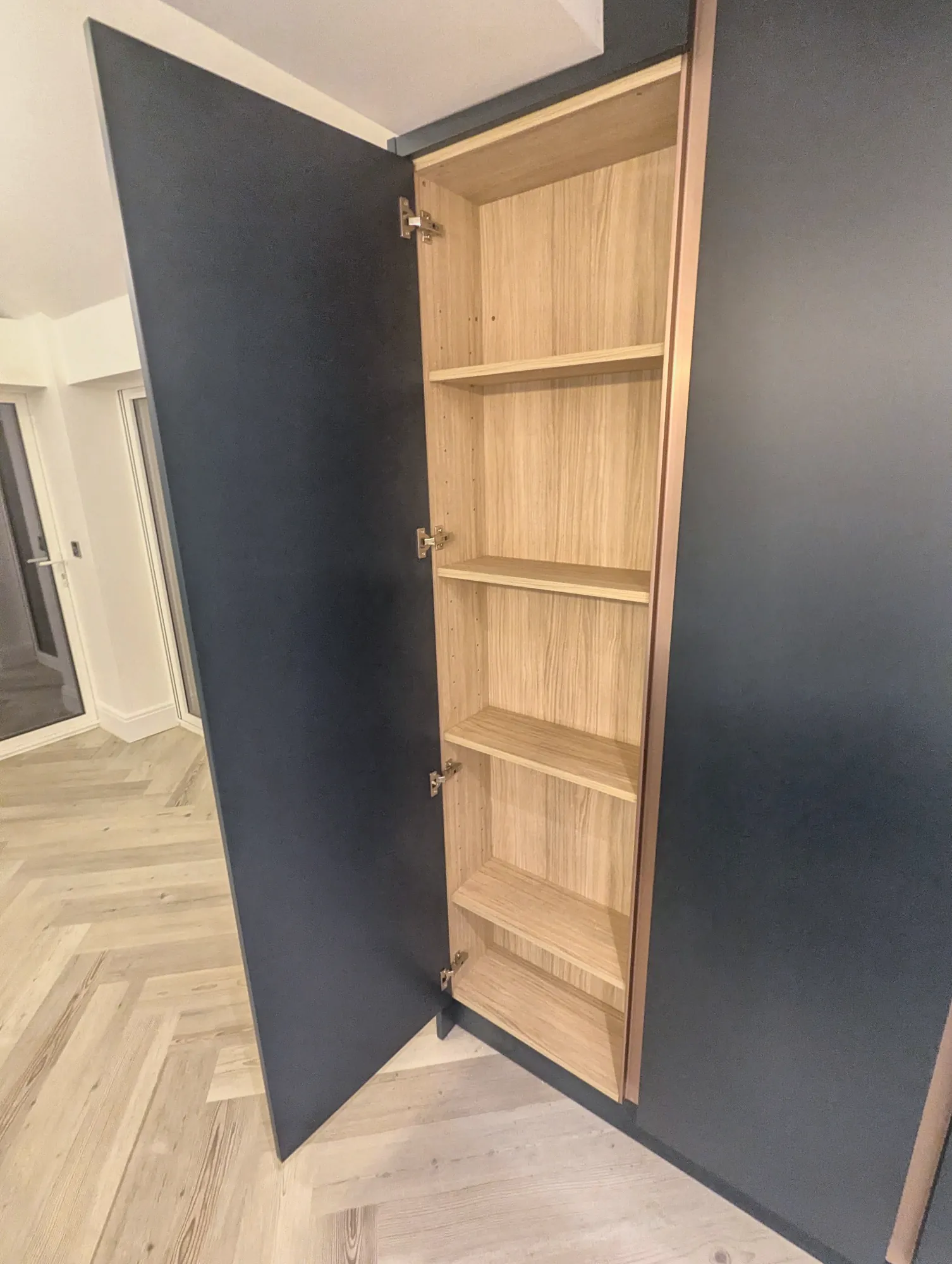 Larder door opened onto oak-lined shelves