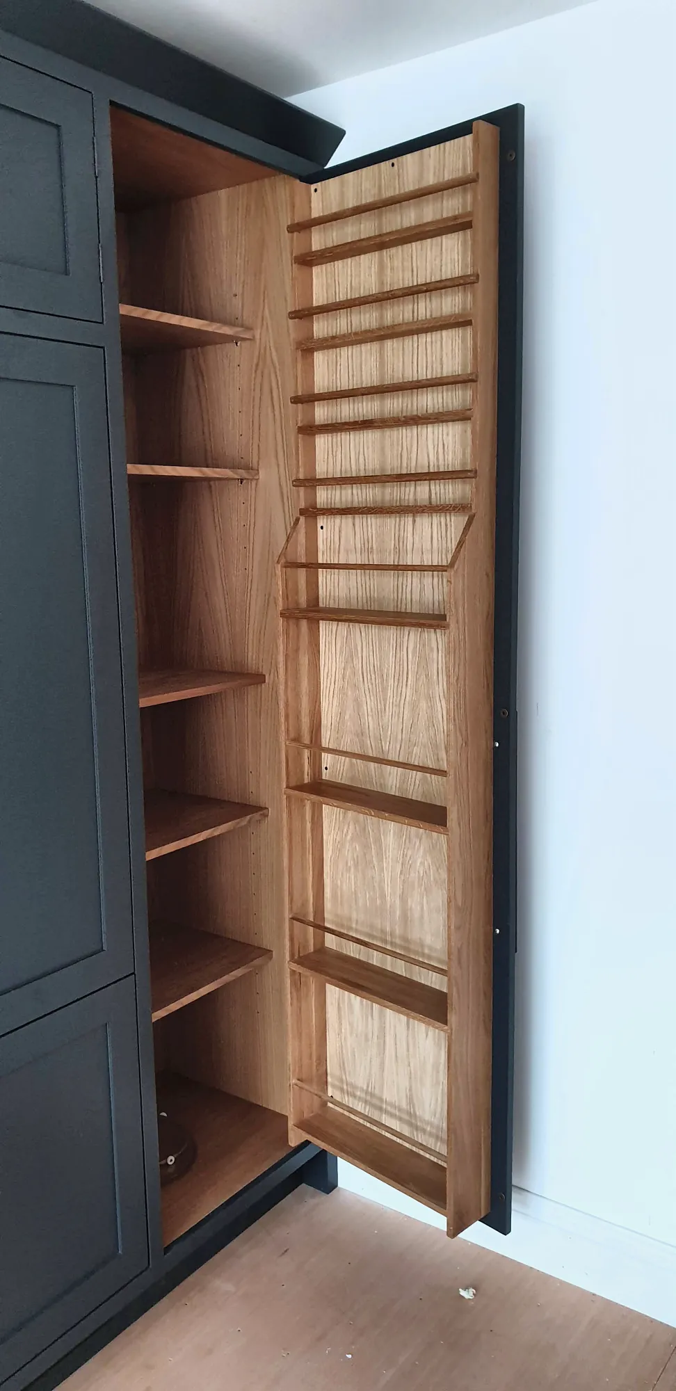 Larder door lined with oak spice racks