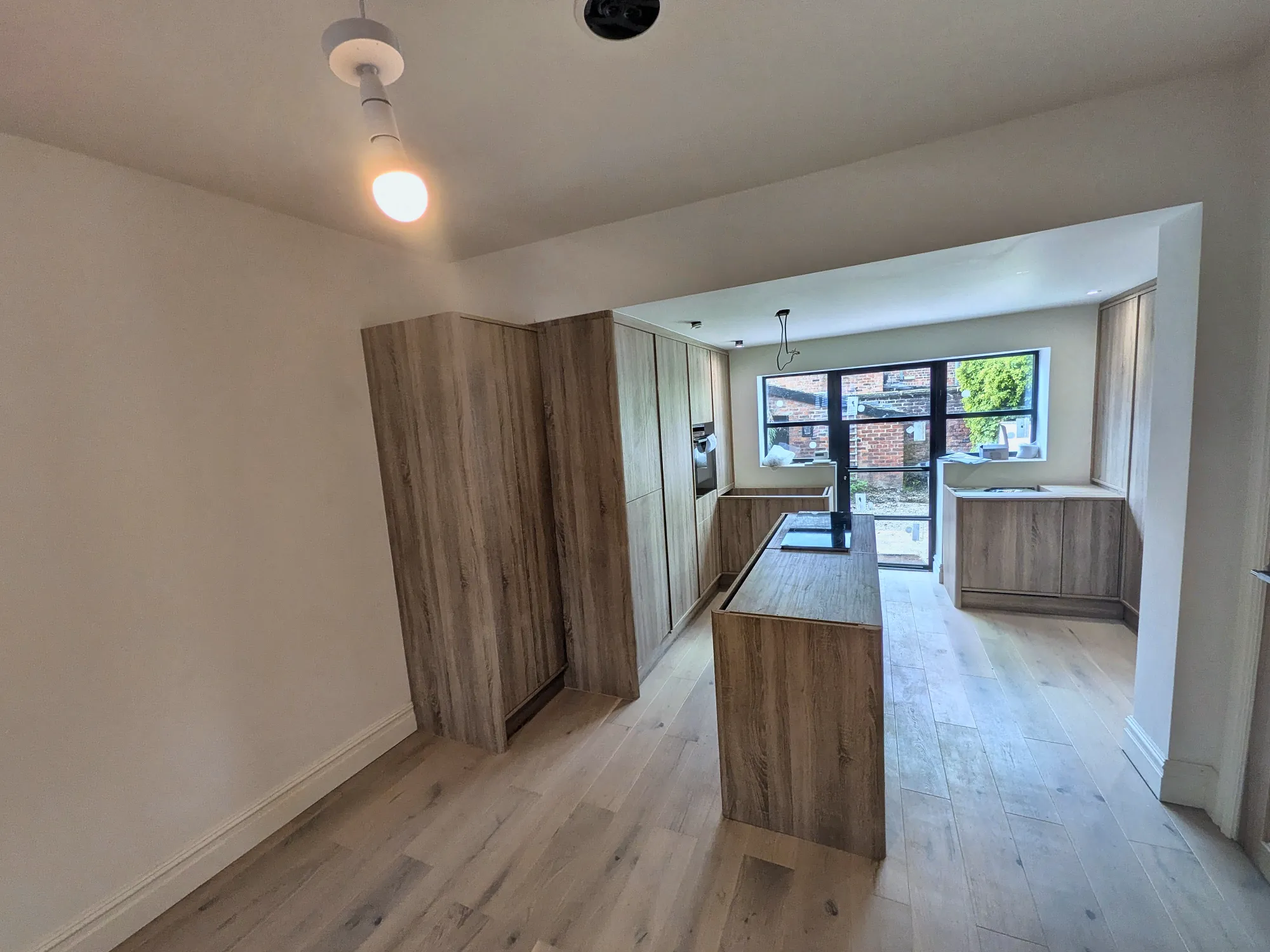 Oak kitchen and island in an open-plan extension