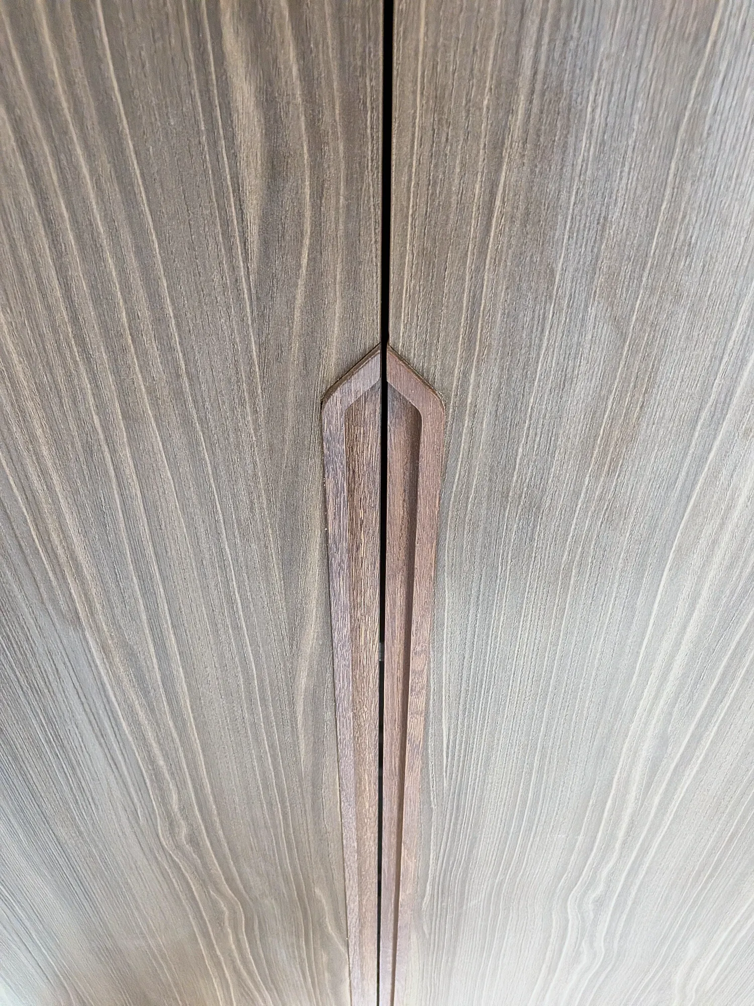 Detail of the routed handle in the oak wardrobe doors