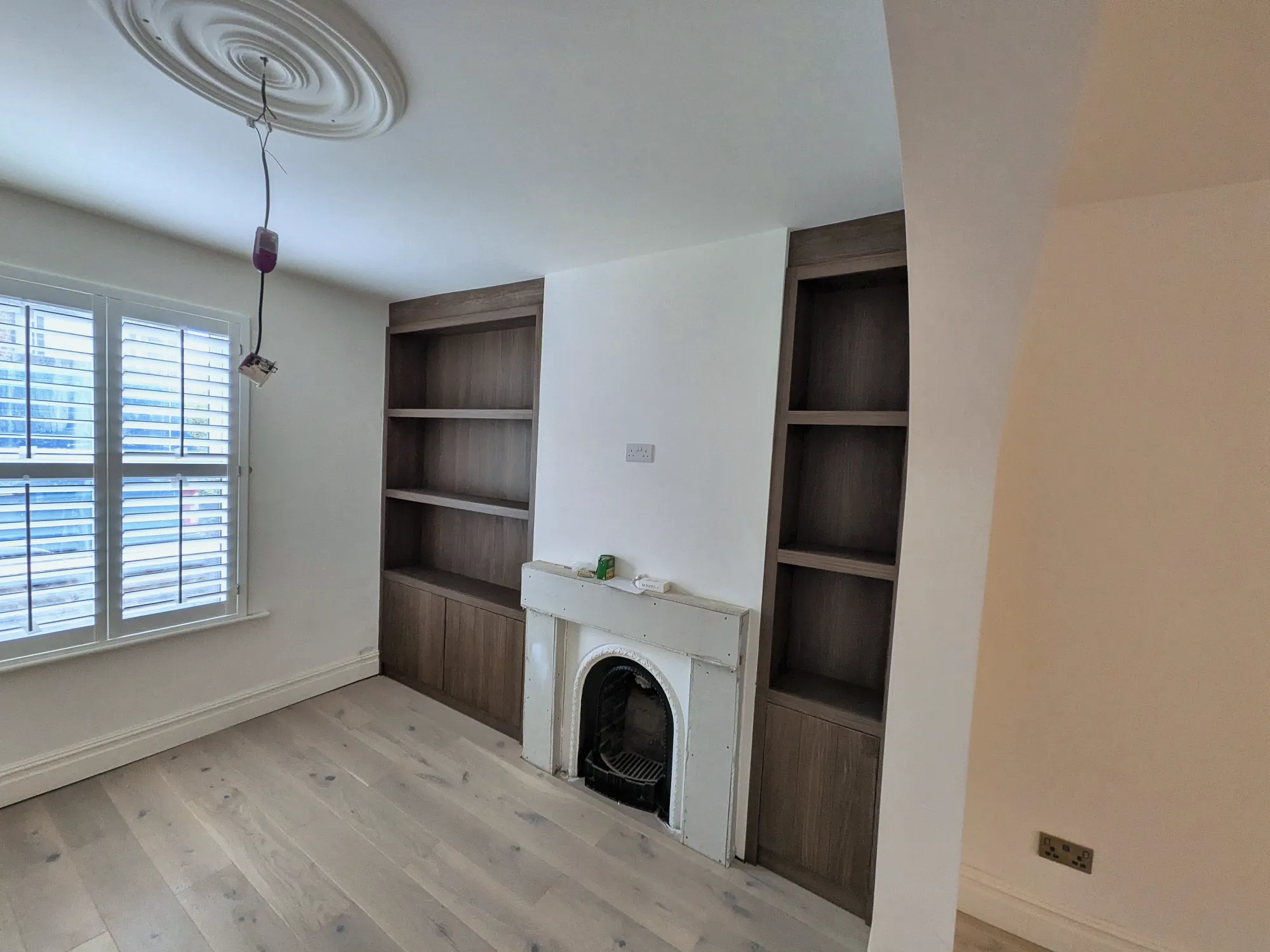Oak alcove shelving beside the fireplace