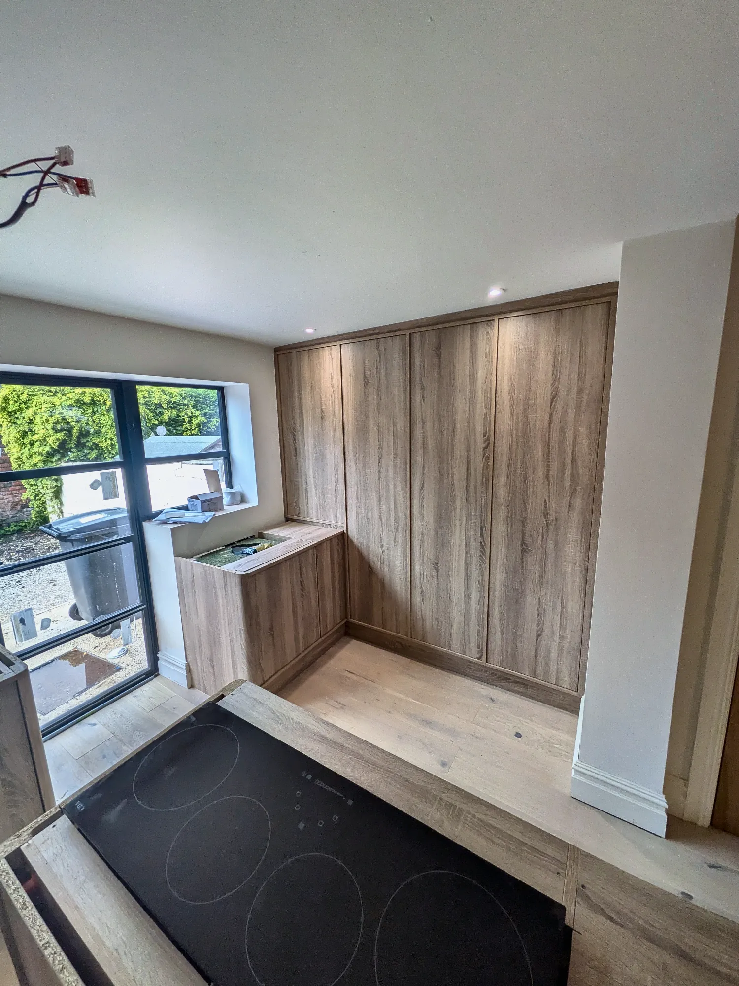 Floor-to-ceiling oak units in the kitchen