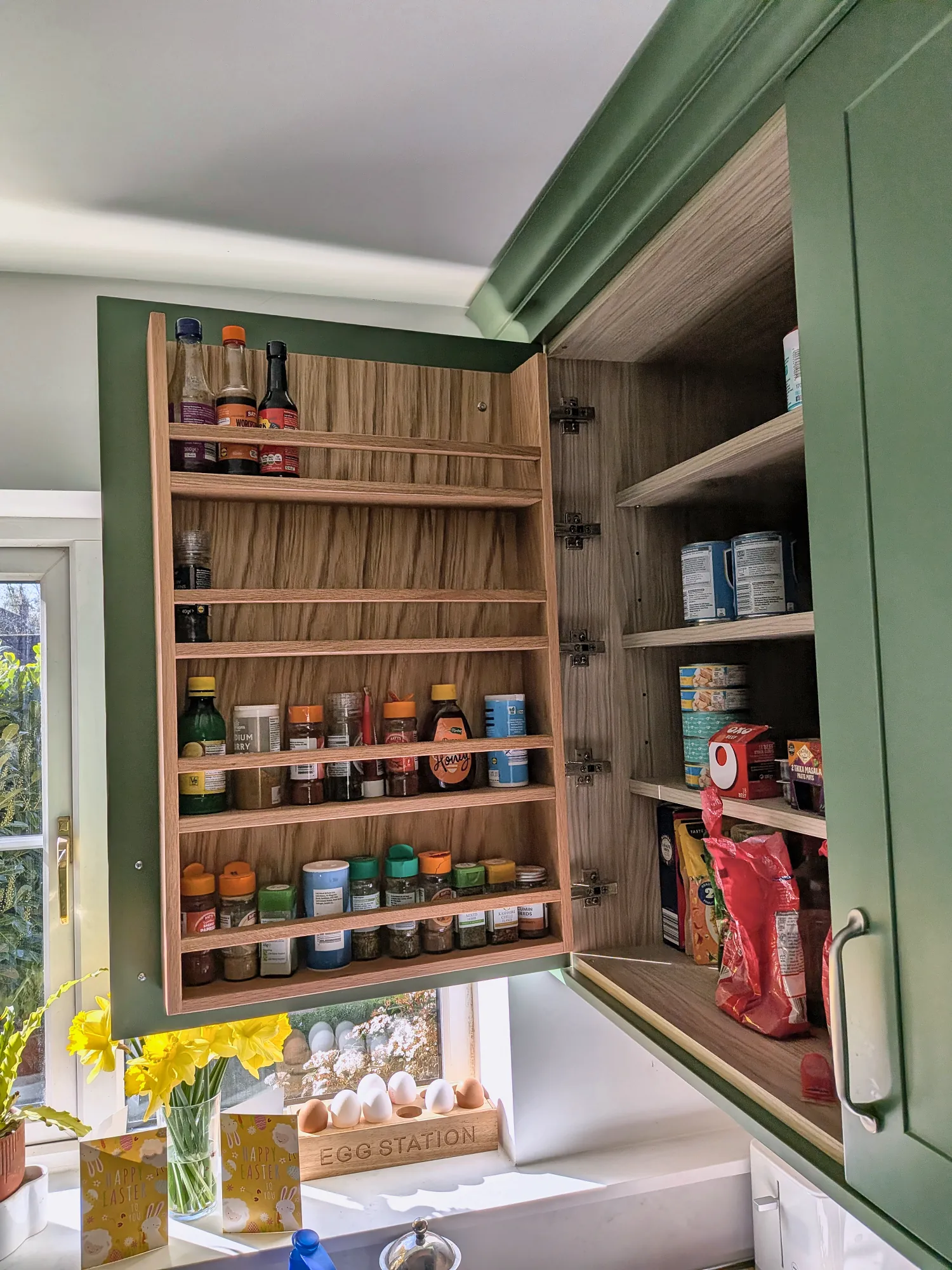 Spice rack fitted inside a wall cabinet door