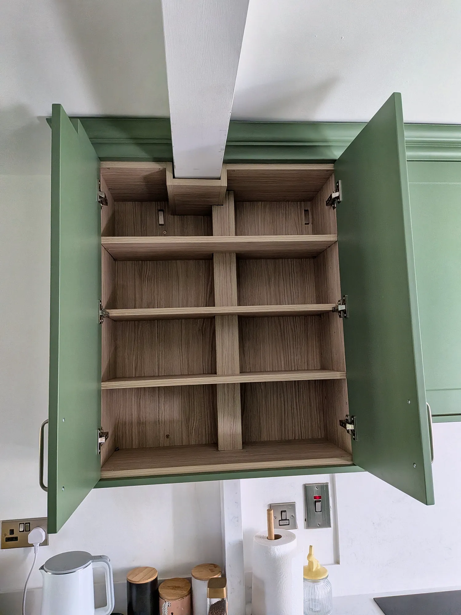 Cabinet interior fitted around a boxed beam