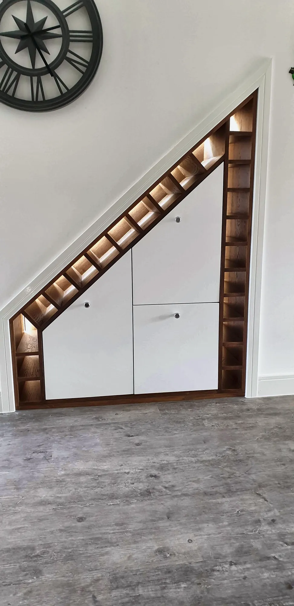 The wine rack following the line of the stairs