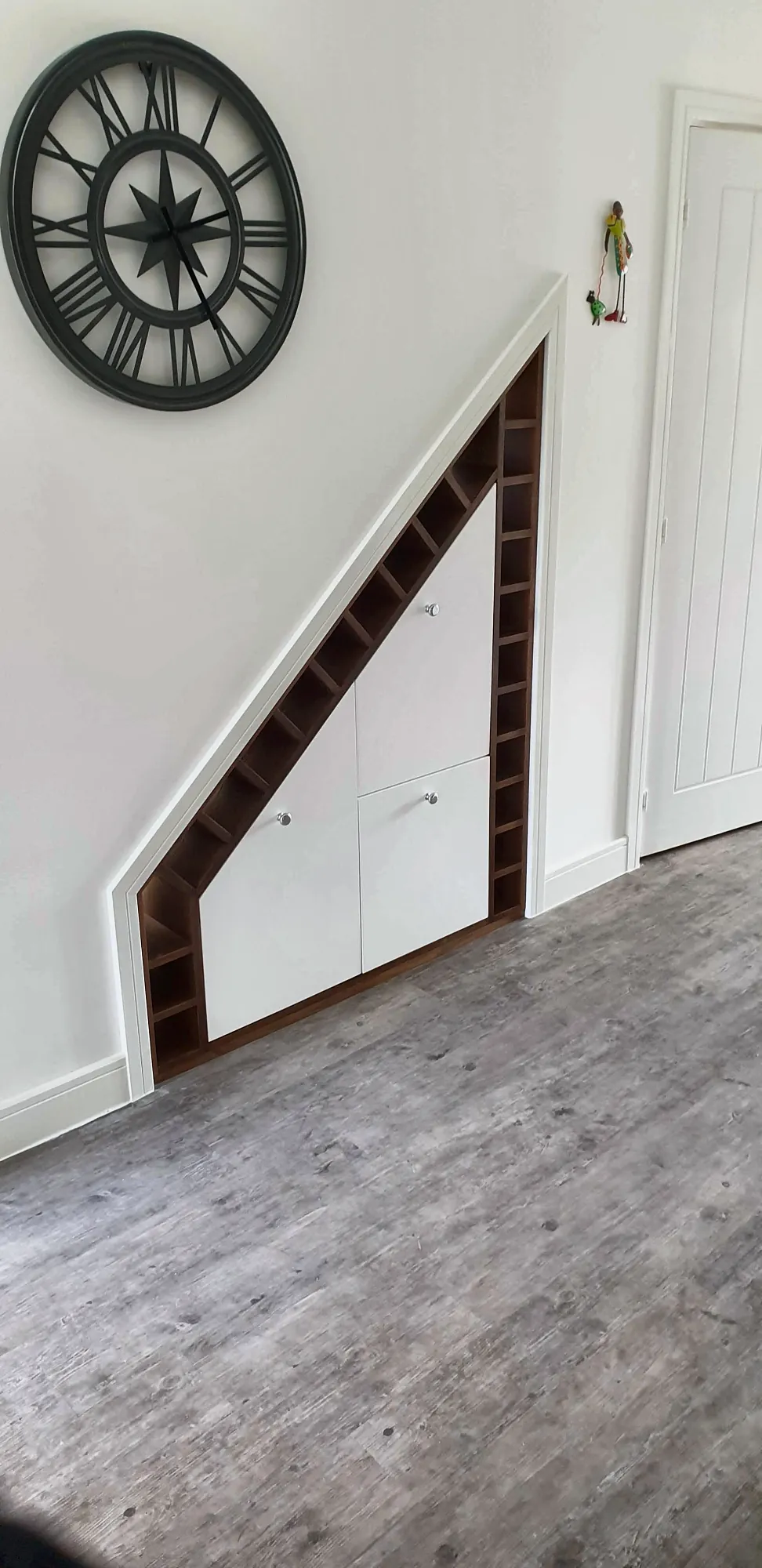 White doors and dark timber wine rack